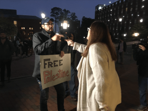 Deborah Friedman confronts protester Andrew Curley on her way to the Genome Science Building to hear Sebastian Gorka's speech Monday evening. (Jay Siebold/Carolina Connection)