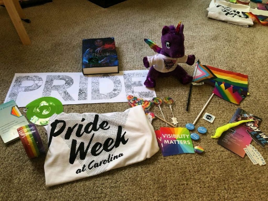 Contents of Pride Week boxes complete with stickers, buttons, flags and a t-shirt. 