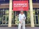 Sharon Lawrence poses in front of a Carolina Playmakers Banner.